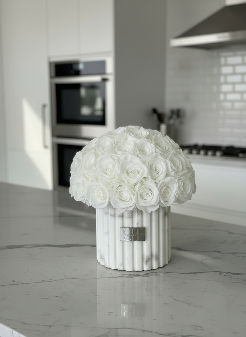 White and grey marble vase with white preserved real roses