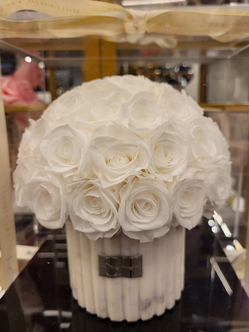 White and grey marble vase with white preserved real roses