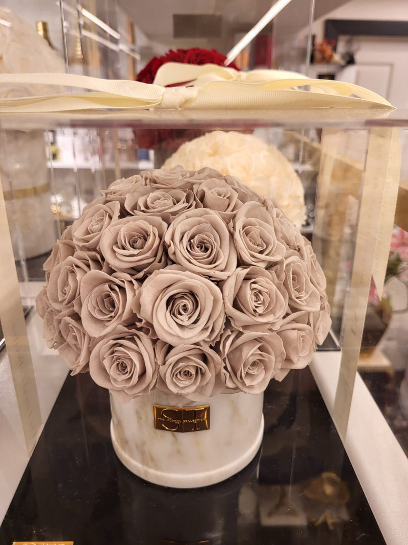 Lavendar real preserved roses in white marble vase