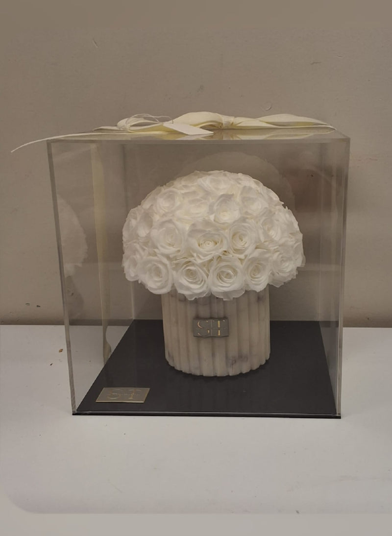 White and grey marble vase with white preserved real roses