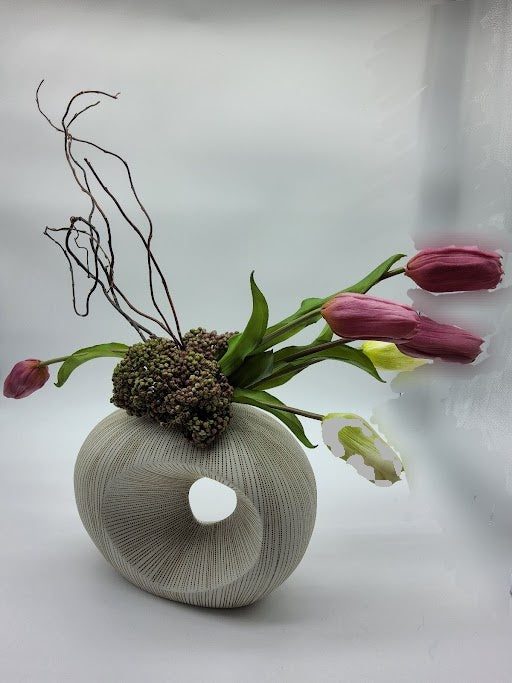 Ivory and Brown textured vase filled with pink and cream tulips, cactus and branches