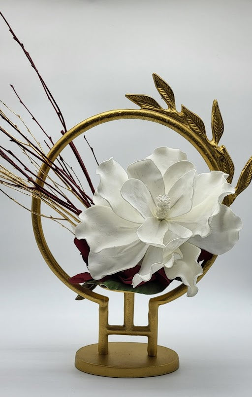 Gold circle hurricane leaf design filled with white /burgundy foam flowers and gold /burgundy branches